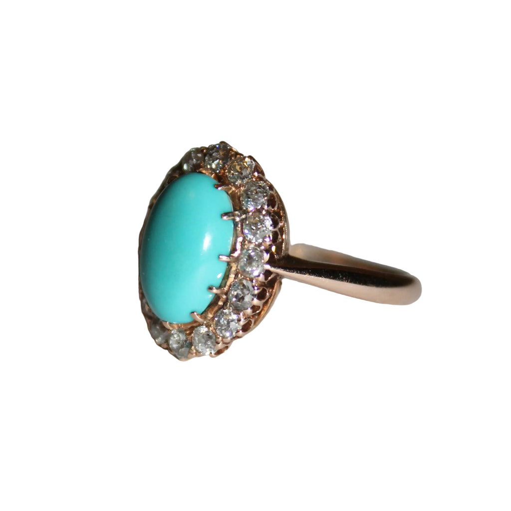 Ring with turquoise stone and diamond accents on a neutral background