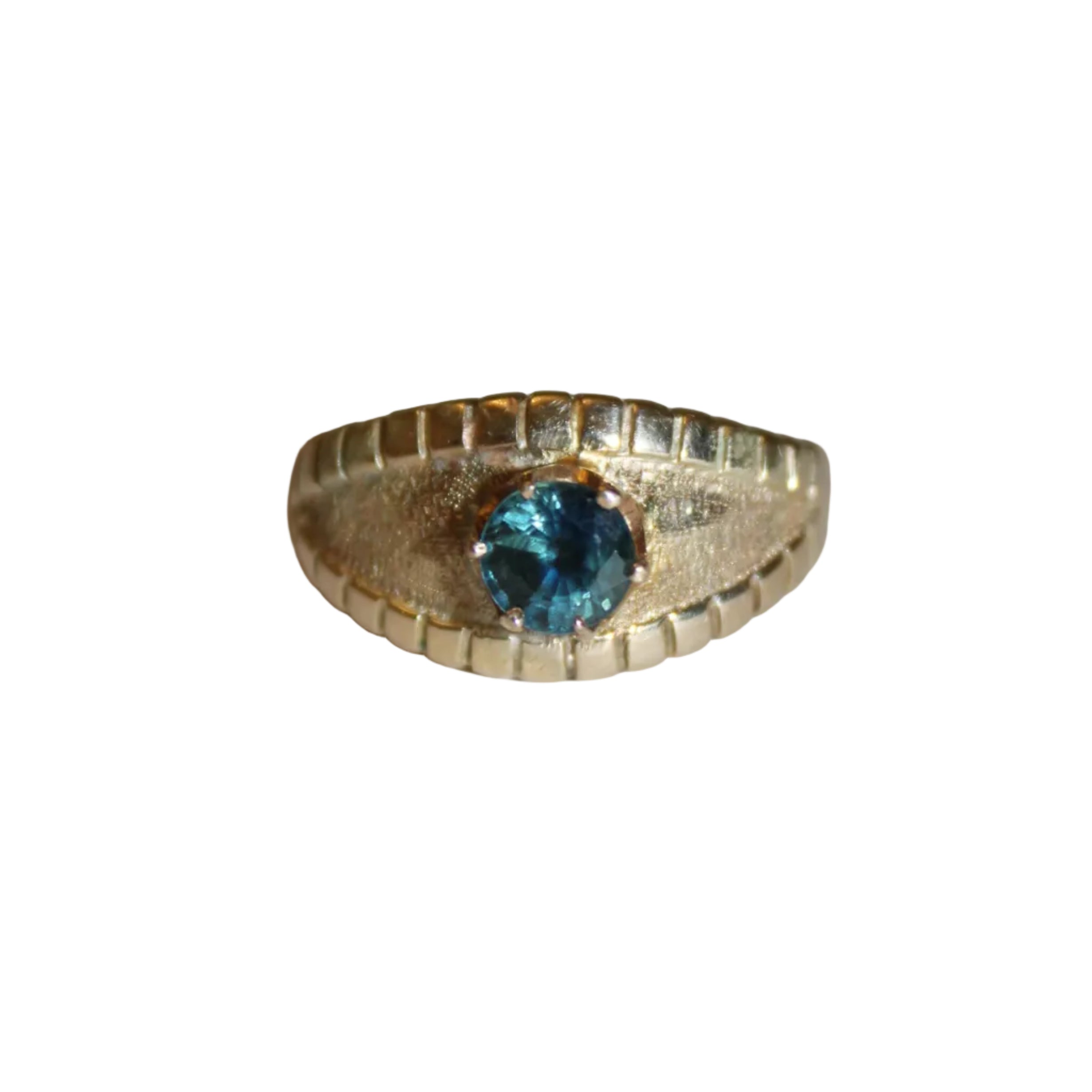 Gold ring with a blue gemstone on a white background