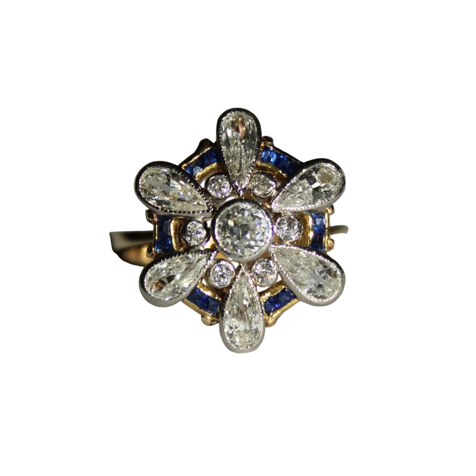 Elegant ring with diamonds and sapphires on a white background
