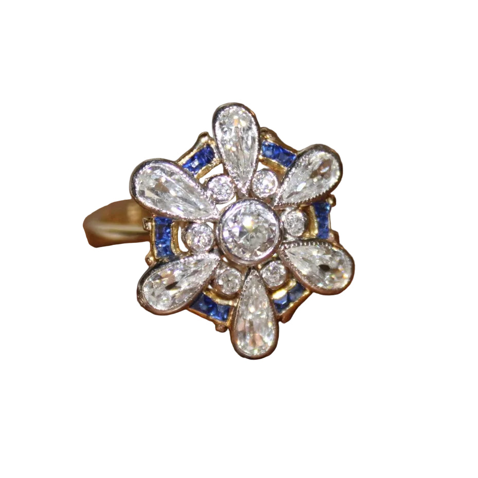 Diamond ring with blue gemstones on a white background