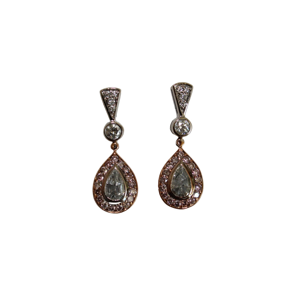 Pair of teardrop-shaped earrings with gemstones on a light gray background