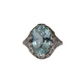 Ring with a large light blue gemstone on a white background