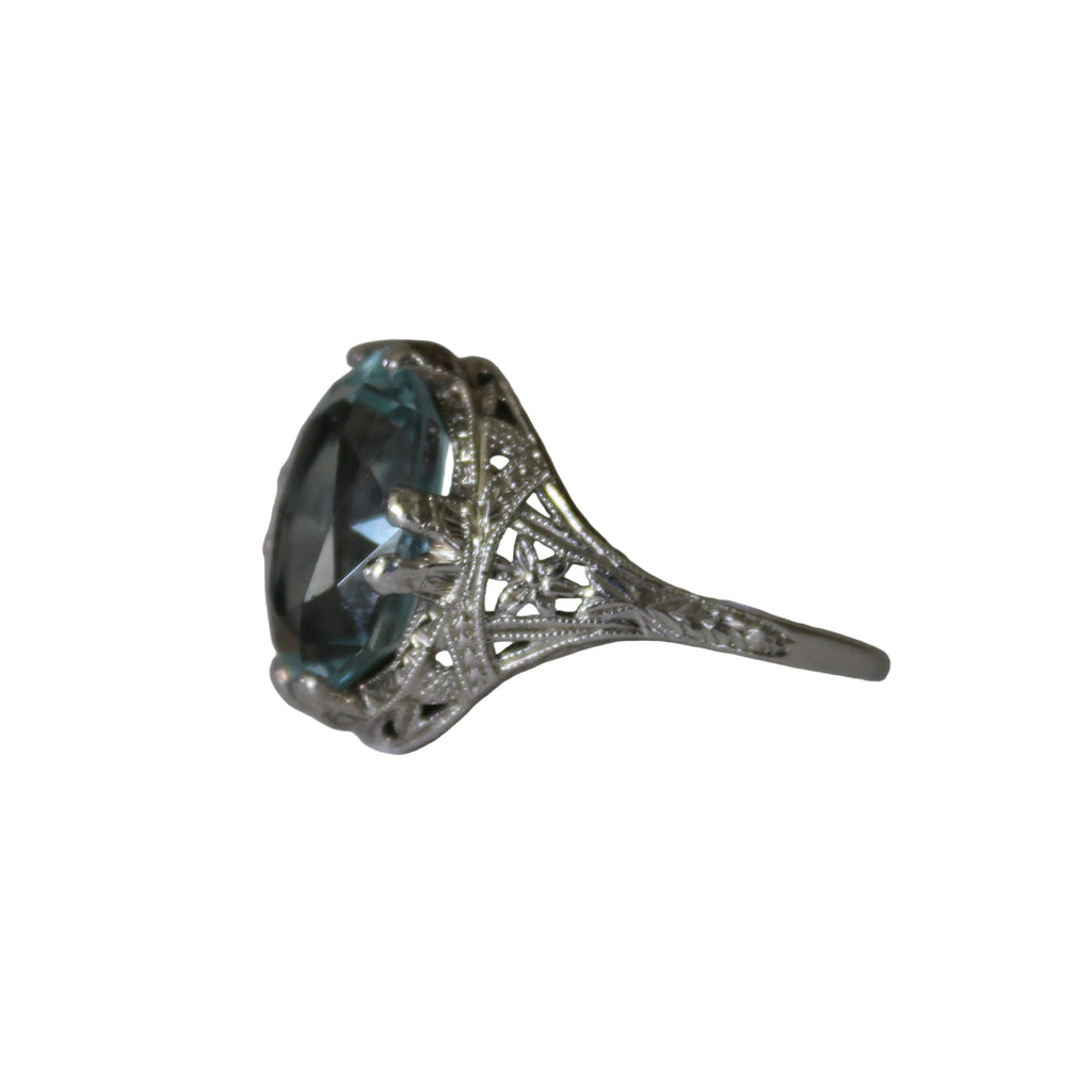 Silver ring with a large blue gemstone on a white background