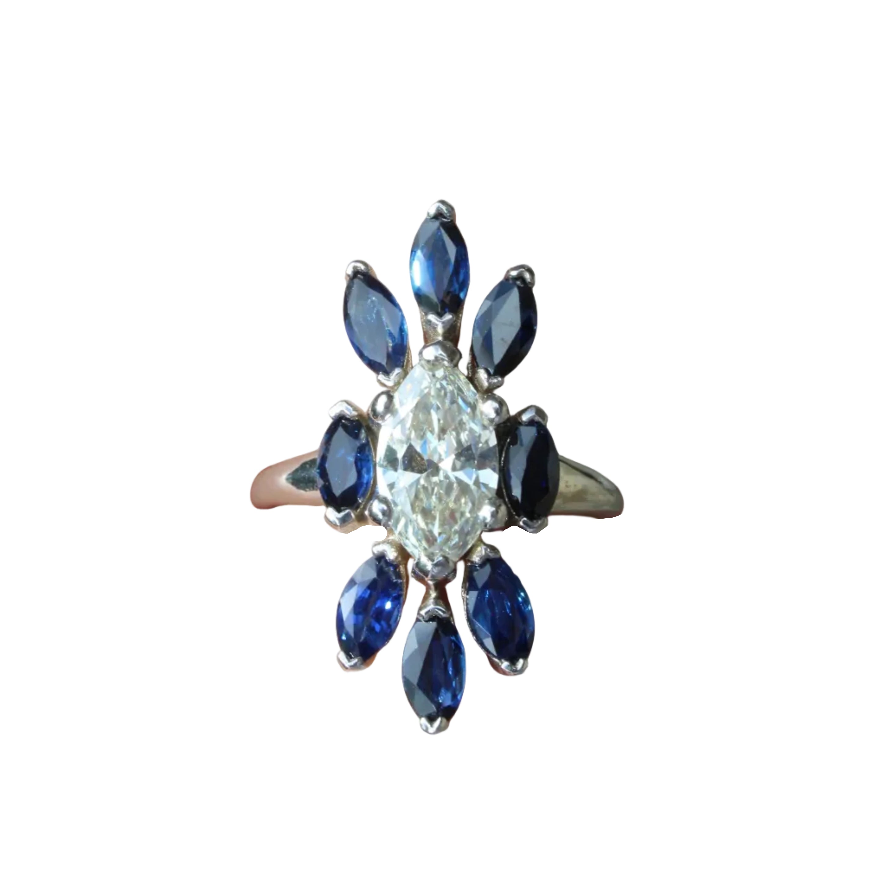 Ring with central diamond and blue gemstones on a white background