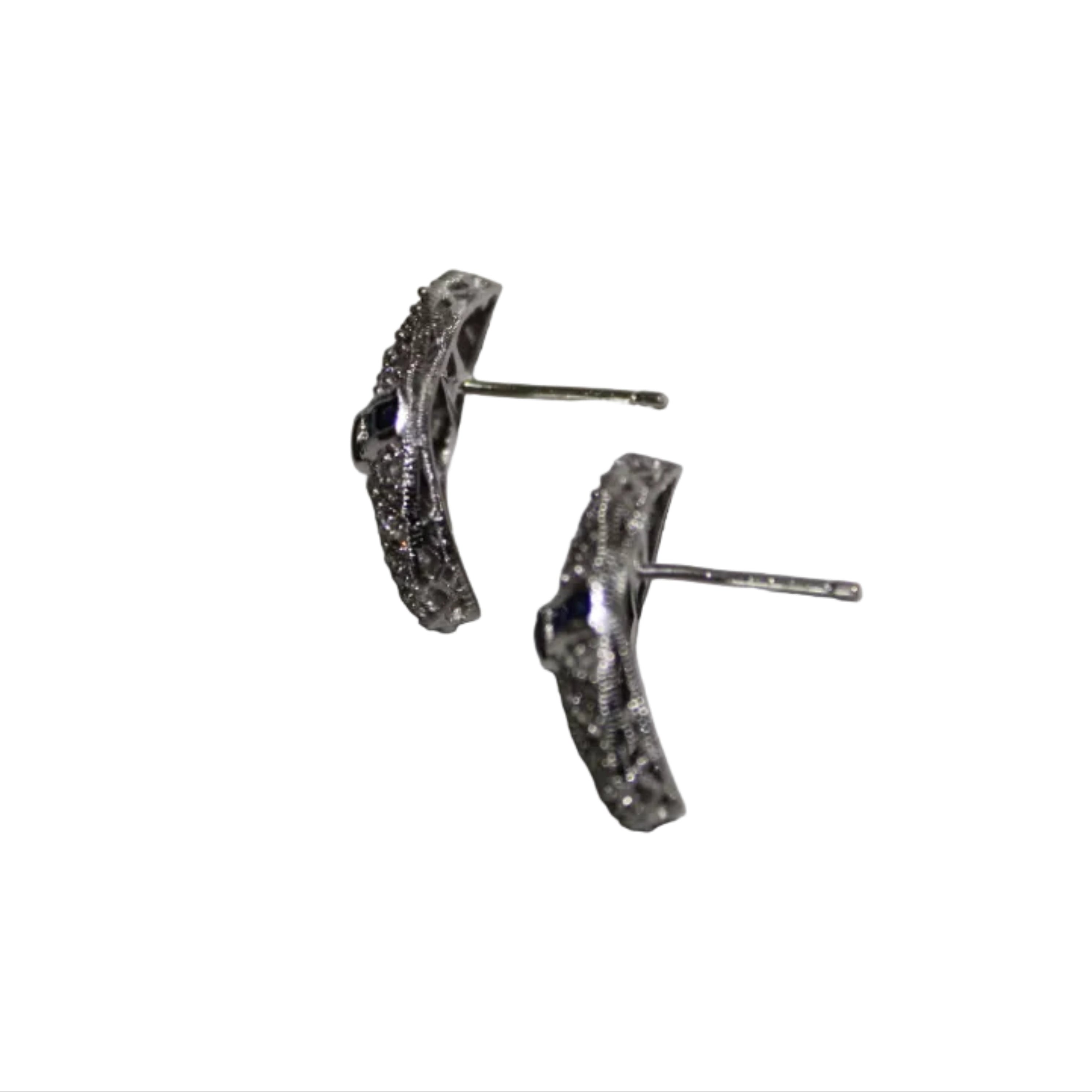 Pair of silver earrings on a light gray background